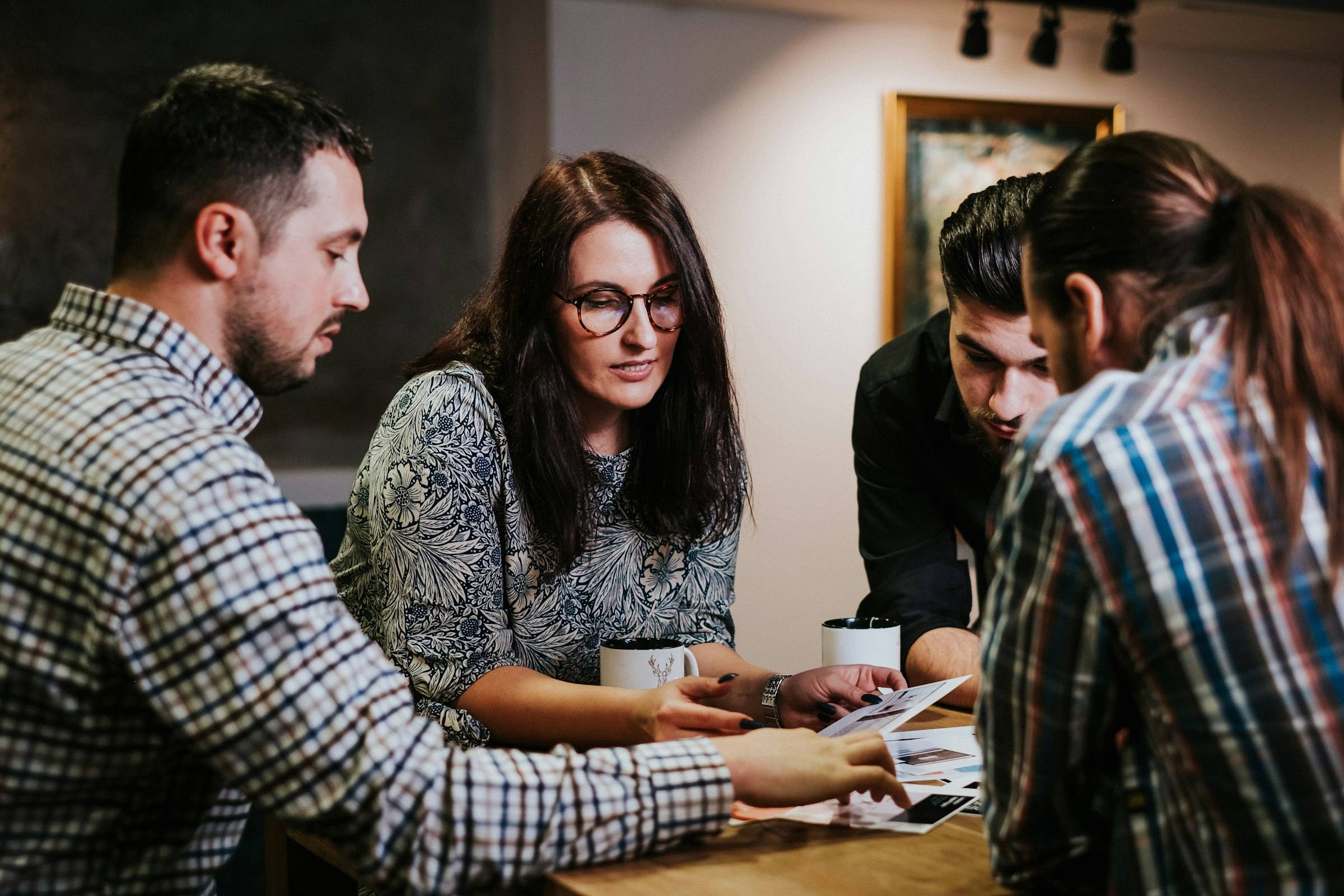 A leadership team gathered around a table, working through a plan together